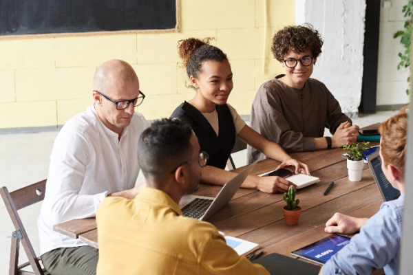 photo-of-people-leaning-on-wooden-table-3184614@2x
